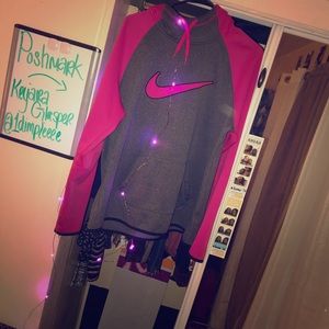 A grey and pink nike hoodie